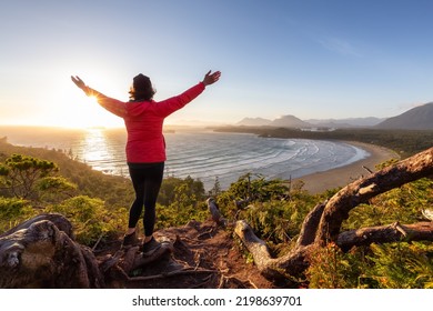 Adventurous Woman Hiker overlooking Sandy Beach on the West Coast of Pacific Ocean. Canadian Nature Landscape Background. Cox Bay Lookout, Tofino, Vancouver Island, BC, Canada. - Shutterstock ID 2198639701