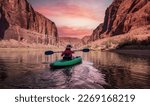 Adventurous Woman on a Kayak paddling in Colorado River. Glen Canyon, Arizona, United States of America. Sunrise Sky Art Render. American Mountain Nature Landscape Background.