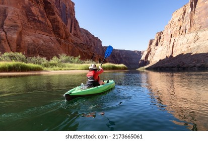 Adventurous Woman on a Kayak paddling in Colorado River. Glen Canyon, Arizona, United States of America. American Mountain Nature Landscape Background. Adventure Travel - Shutterstock ID 2173665061
