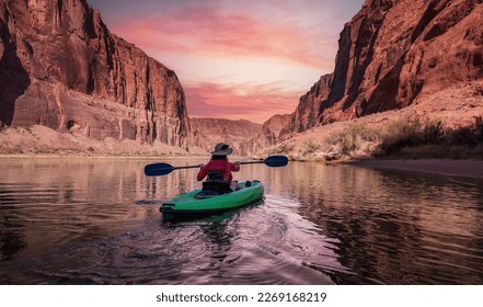 Adventurous Woman on a Kayak paddling in Colorado River. Glen Canyon, Arizona, United States of America. Sunrise Sky Art Render. American Mountain Nature Landscape Background.