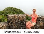 Adventurous young woman on top of Torre Britton in the beautiful jungle of the El Yunque national forest in Puerto Rico 