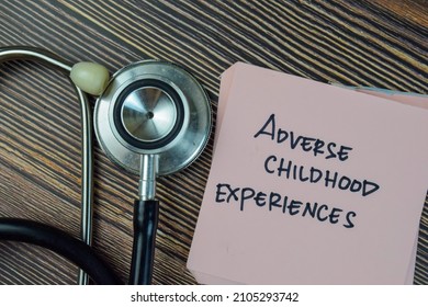 Adverse Childhood Experiences Write On Sticky Notes Isolated On Wooden Table.