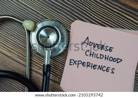 Adverse Childhood Experiences write on sticky notes isolated on Wooden Table.