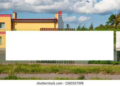 Advertising banner mockup on the fence of factory/warehouse building