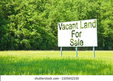 Advertising billboard immersed in a rural scene with Vacant Land for Sale written on it - image with copy space