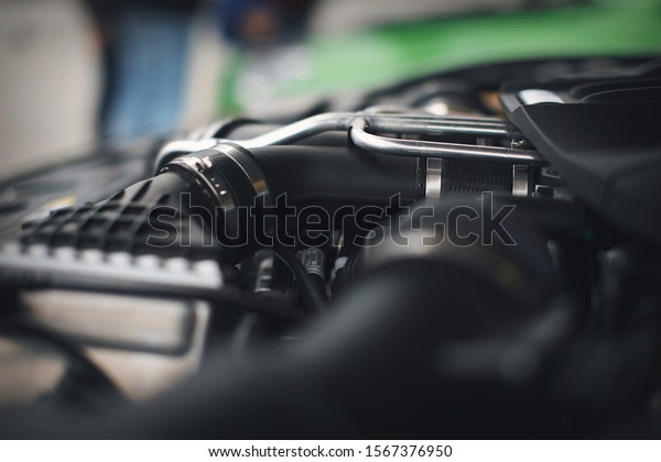 advertising\
BMW cars, Moscow, 1.11.2018: Car repair and cleaning concept - car\
engine close-up, wiping parts under the\
hood