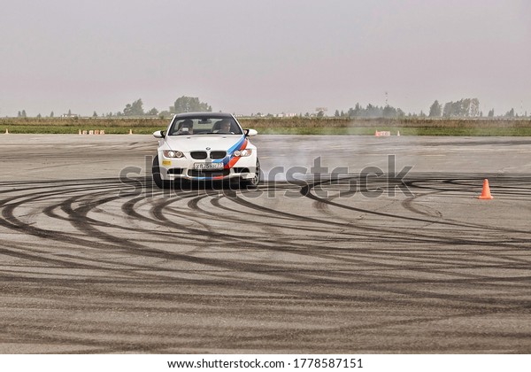 advertising BMW, Moscow, 1.11.2018:\
demonstration of the white car model, cars in the test track, dust\
from under the wheels, tracks on the road, race, driving training\
in a driving school,\
delivery