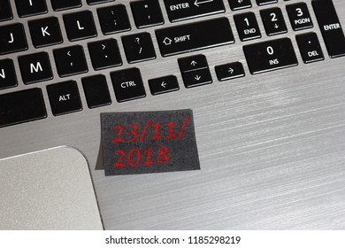 Advertising message about Black Friday on black post it: reminder on silver laptop. - Powered by Shutterstock