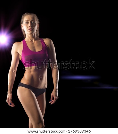 Similar – One young middle age athletic woman at crossfit training, exercising with trx suspension fitness straps over dark background, front view, looking up