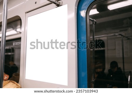 Advertising poster, banner on the wall of a train car in the subway. Free space. Outdoor advertising in public transport, subway car.