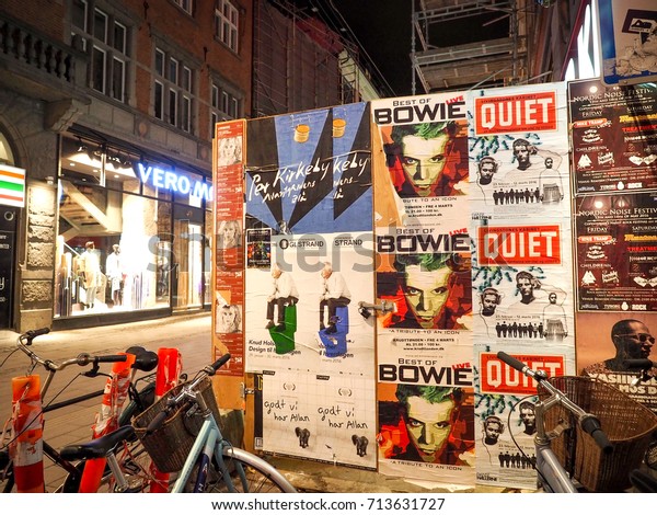 Advertising poster with bikes night view\
street in Copenhagen City, Denmark at 22 Feb\
2016.