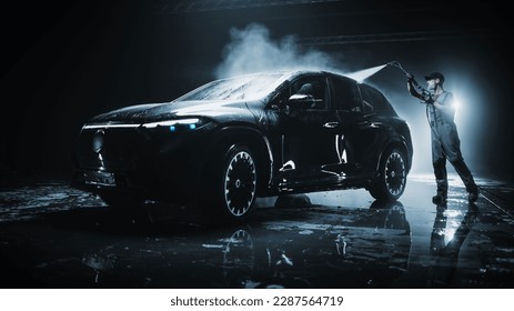 Advertising Style Photo of a Professional Car Wash Specialist Using a High Pressure Washer to Clean and Prepare a High Tech Black Family Electric SUV for Detailing, Polishing and Waxing