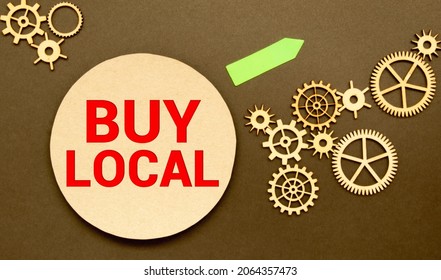 Advice To Buy Local Printed On A Brown Paper Price Tag As A Means Of Supporting Local Suppliers And Producers.