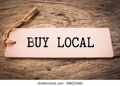 advice to Buy Local printed on a pink paper price tag 