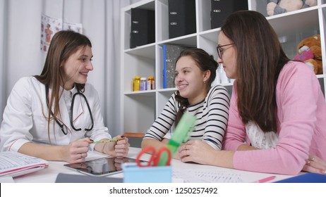 Advice In The Doctor's Office. Mother And Daughter A Teenager In The Office Of The Family Doctor.