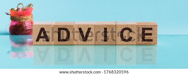 Advice word\
from wooden blocks with letters, to divide or use something with\
others share concept, blue\
background