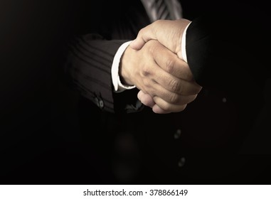 Advocacy Concept: Two Successful Business Men Shaking Hands After Good Deal