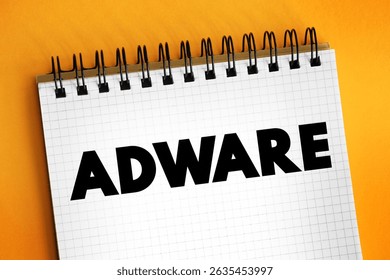 Adware - unwanted software designed to throw advertisements up on your screen, text concept on notepad