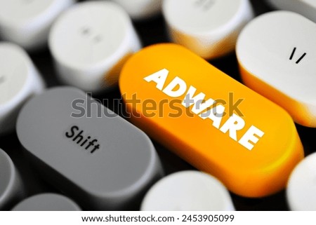 Adware - unwanted software designed to throw advertisements up on your screen, text concept button on keyboard