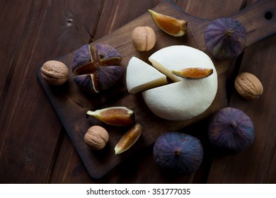 Adygea cheese with fresh fig fruits and walnuts, view from above - Shutterstock ID 351777035
