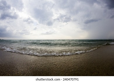 Aegean Sea, Beach And Sky With Clouds Before The Storm. Fish Eye Lens Effect 