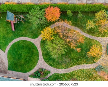 Aerail view of walk path between multicoloroed bright vibrant garden tree first fallen dry leaves on green grass lawn at home yard or city park in october. Autumnal scenic nature foliage backgound - Powered by Shutterstock