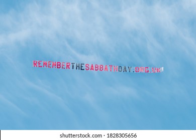 Aerial advertising or skywriting - a standard letter banner 'remember the Sabbath Day' Christian message towed by plane