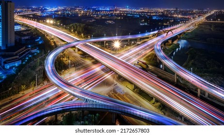 Aerial angle Rush hour traffic fast moving hyper lapse at night overhead of busy intersection traffic at night moving fast light road lane effect line light cg
