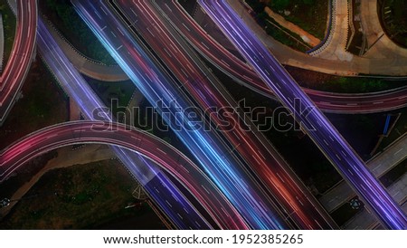Aerial angle Rush hour traffic fast moving hyper lapse at night overhead of busy intersection traffic at night