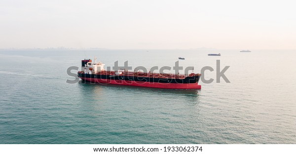Aerial angle side view\
of oil tanker container ship at sea. Crude oil tanker lpg ngv at\
industrial estate Thailand - Oil tanker ship to Port of Singapore -\
import export 