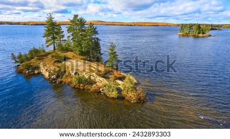 Aerial Autumn Island in Lake with Forested Shoreline