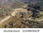 Aerial and autumnal view of dirt trail and ponds at Dolline Wetland at Gulbongsan Mountain of Ugok-ri near Mungyeong-si, South Korea 
