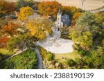 Aerial and autumnal view of maple trees with tourists on the yard in front of building of Gongseri Cathedral near Asan-si, South Korea
