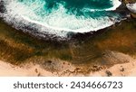 Aerial beach sea shore white sand pattern wave ocean coast line bay vertical top down