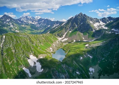 Aerial beautiful summer landscape of Caucasus mountain. Skazka of Caucasus lake near Arkhyz village in Russia. Daylight mountain landscape.