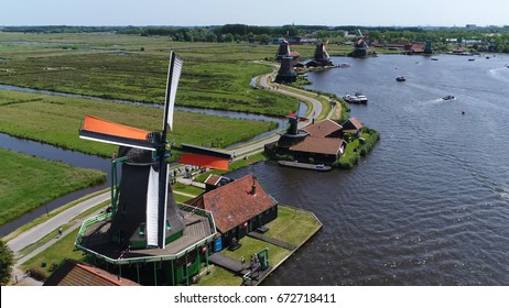 Aerial bird-eye photo of Zaanse Schans Zaandam flying past one of well-preserved historic windmills for tourists this is one of the most popular tourist attractions near Amsterdam Holland Netherlands