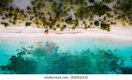 Aerial Bird's Eye Drone View Of A Beautiful Tropical Vacation Beach With Crystal Clear Blue Water, White Sand, Palm Trees, And A Kayak And Lifeguard Tower In Riviera Maya, Mexico Near Cancun.