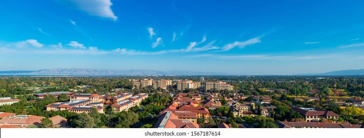 Aerial bird's eye panoramic view of scenic Silicon Valley, southern San Francisco Bay Area skyline during fall season under blue sky with light clouds