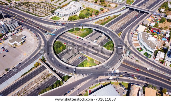 Aerial bird\'s eye photo of highway and ring road\
passing through city\
center