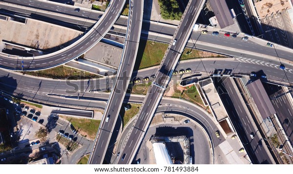 Aerial bird\'s eye photo of highway passing through\
city center