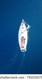 Aerial Birds Eye Top View From Drone Of Sail Boat Cruising In Deep Blue Sea