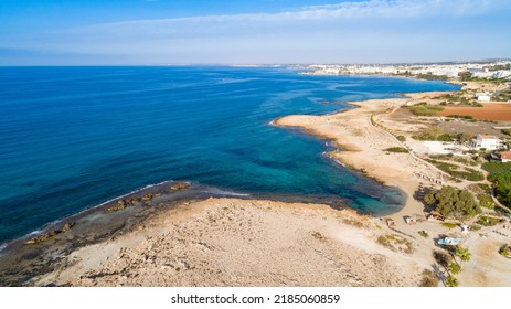 Aerial bird's eye view of Ammos tou Kambouri beach, Ayia Napa, Cavo Greco, Famagusta, Cyprus. Tourist attraction bay, rocky beach with golden sand, sunbeds, sea restaurant in Agia Napa from above.