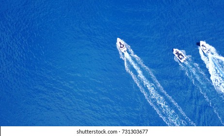 Aerial Birds Eye View From Drone Of Boats Cruising In Deep Blue Sea