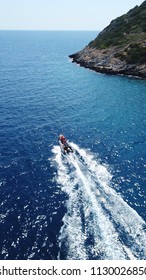 Aerial bird's eye view of inflatable rib boat cruising in high speed in deep blue mediterranean sea