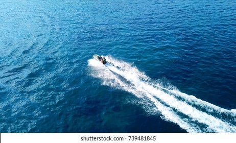 Aerial Bird's Eye View Of Jet Ski Cruising In High Speed In Turquoise Clear Water Sea