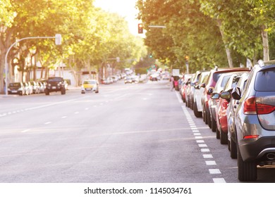 Aerial Car Parking Lot Outdoors, Backside Cars In Row Parking On The Side Of The Road. Background Traffic Lights Road And No Traffic Jam.  Concept Transportation 