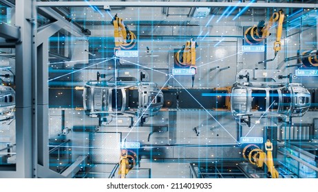 Aerial Car Top View Factory Digitalization Concept: Automated Robot Arm Assembly Line Manufacturing High-Tech Electric Vehicles. AI Computer Vision Analyzing, Scanning Production Efficiency. - Shutterstock ID 2114019035