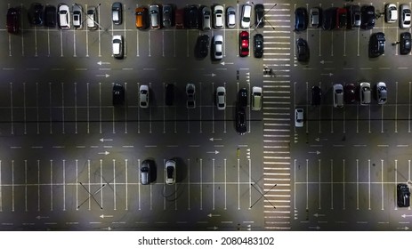 Aerial. Cars On The Night Parking Lot Near The Mall. Top View From Drone.