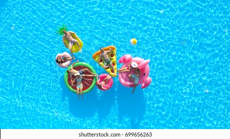 AERIAL: Cheerful Fit People On Summer Vacation Enjoying On Fun Inflatable Floats