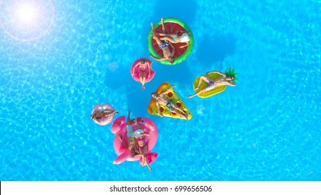 AERIAL: Cheerful Fit People On Summer Vacation Enjoying On Fun Inflatable Floats